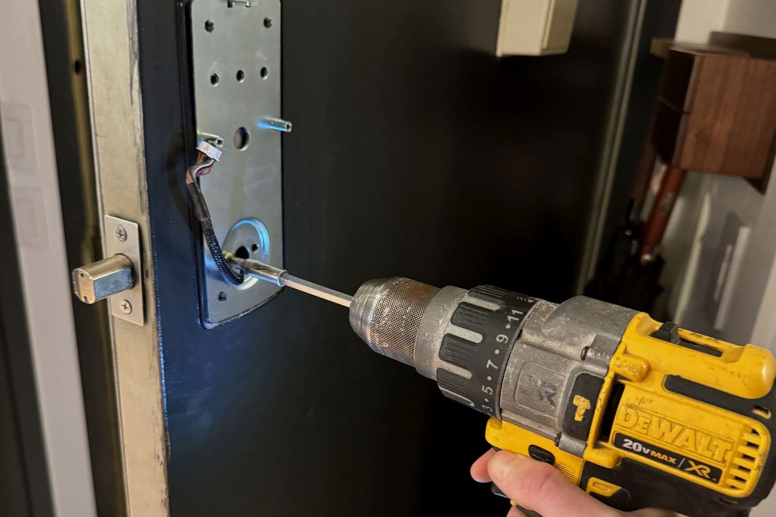 Keypad lock plate with its cable attached, ready to mount on a door